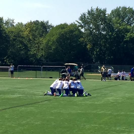 The starting lineup huddles before the game.