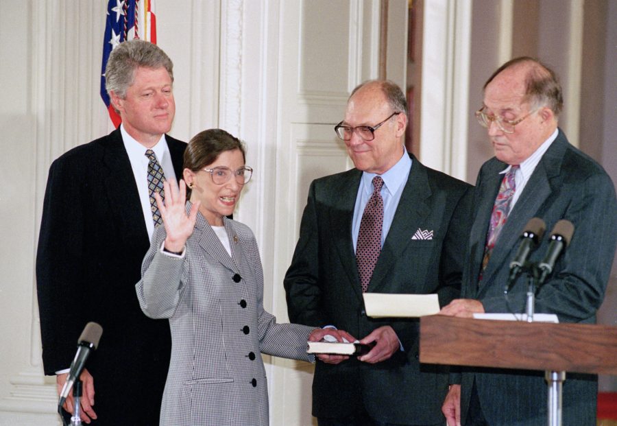 FILE - In this Aug. 10, 1993, file photo, Supreme Court Justice Ruth Bader Ginsburg takes the court oath from Chief Justice William Rehnquist, right, during a ceremony in the East Room of the White House in Washington. Ginsburgs husband Martin holds the Bible and President Bill Clinton watches at left. The Supreme Court says Ginsburg has died of metastatic pancreatic cancer at age 87. (AP Photo/Marcy Nighswander, File)