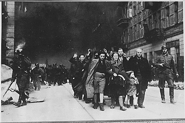 Jewish civilians march during the 1943 destruction of the Warsaw Ghetto. This event was created and organized by hundreds of women involved in the Jewish resistance.