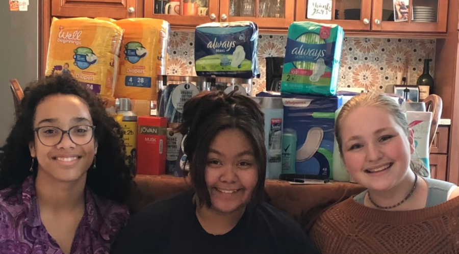 SPF Seniors Amelia Collins, Natalie Green and Rica Lopez pose in front of various Her Drive donations. The satisfaction of helping people inspired Collins, Green and Lopez to plan more donation drives in the near future. 