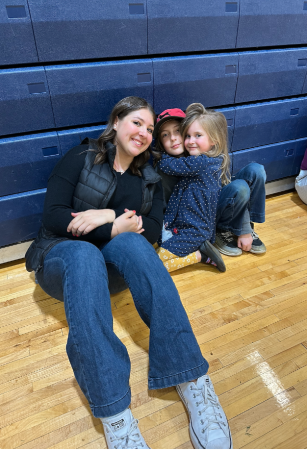 Junior Emersyn Teicher takes English Teacher Christina Held’s children to the gym. They played many fun games, including duck-duck-goose. 