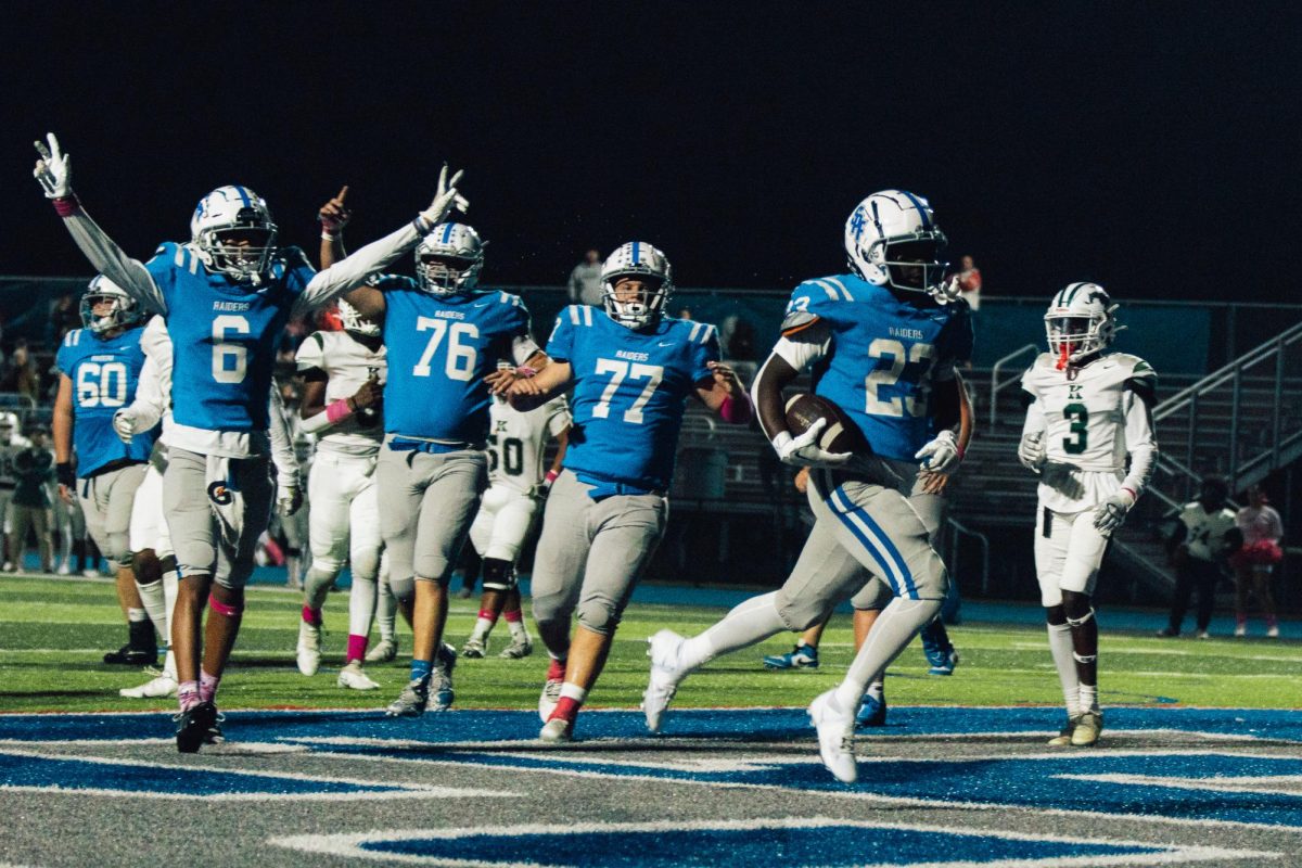 Junior+running+back+Jayden+Richards+%2823%29+runs+into+the+endzone+with+his+teammates+celebrating+behind+him.+The+Raiders+won+39-0+against+the+JFK+Mustangs+on+Friday+Night%2C+Oct.+20+at+Perry+Tyson+Field.