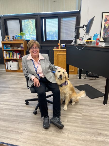 Spiffy, eager to play fetch, patiently sits next to superintendent Dr. Joan Mast in her office. Dr. Mast has owned Spiffy since he was a puppy. 