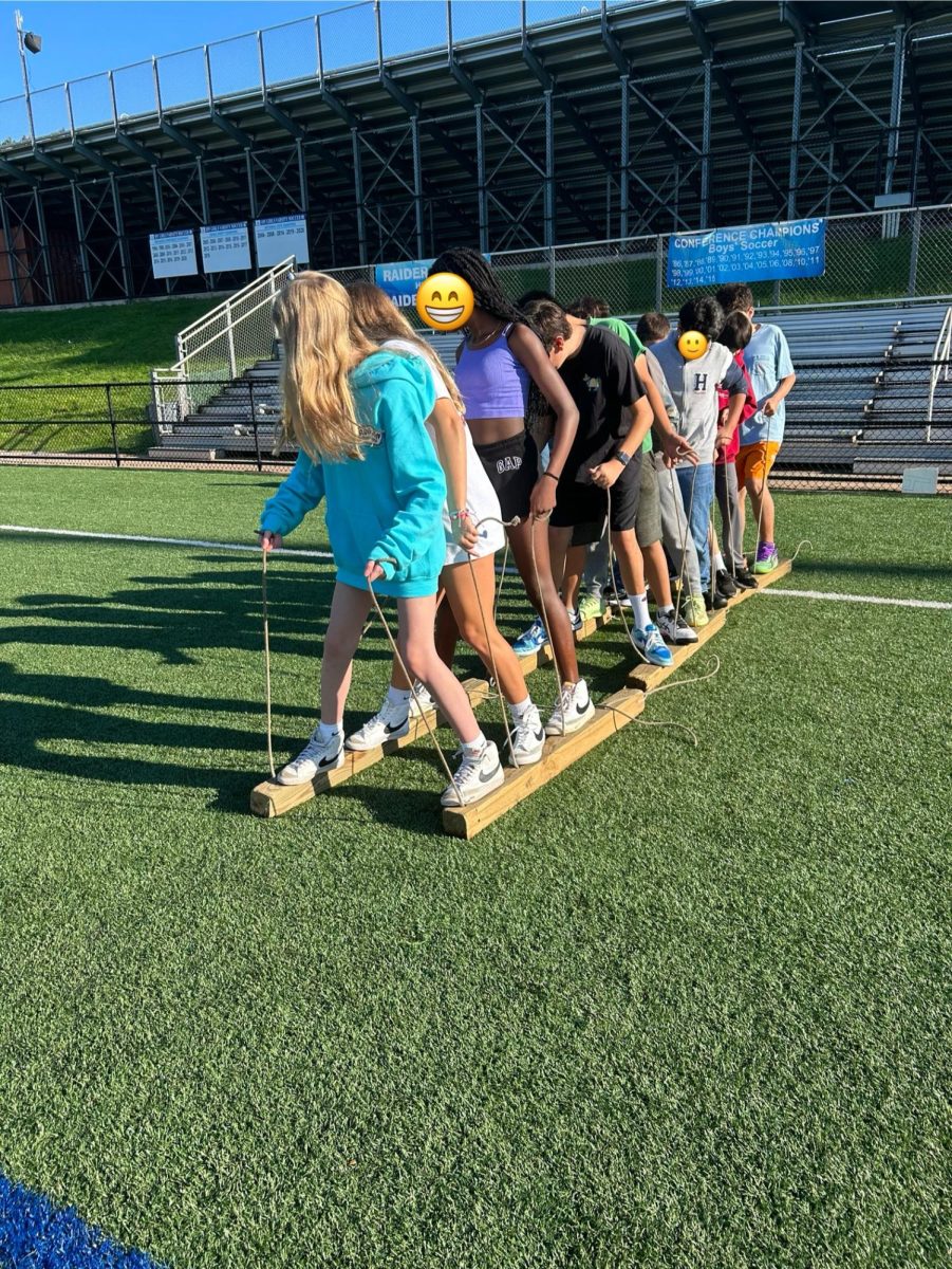 This photo was taken on Oct. 4 on the SPFHS soccer field during Project Adventure. The activity the 7th graders are doing is Wooden Skis.