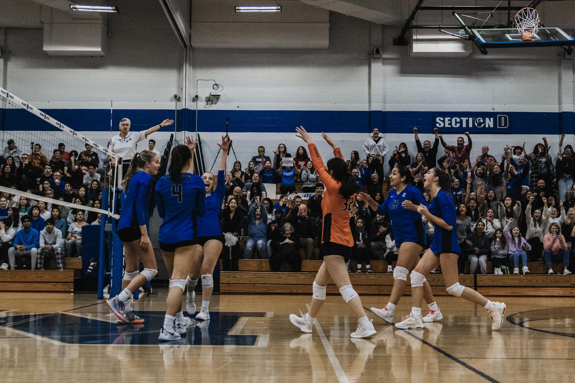 The Raiders celebrate after winning a point off of a Danielle Kramer block. The SPF Girls Volleyball team lost 2-1 (13-25, 25-22, 18-25) to the Millburn Millers on Tuesday Nov. 6 at Millburn High School. 