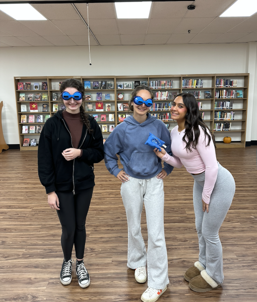 Students participate in games wearing distortion goggles. This activity took place in the media center. 