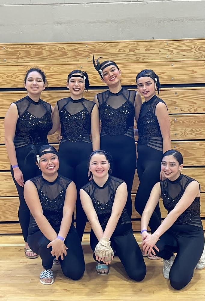 The 2023 Winter Guard poses after a competition award ceremony. Their show was an upbeat 1920’s dance, which was reflected in their costumes. 