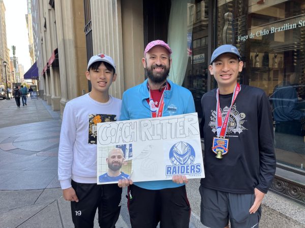 Mr. Ritter poses with Alex Ho (left) and alumni Max Ho (right) after the race. Max Ho ran his first marathon, while Ritter ran his fifth. 