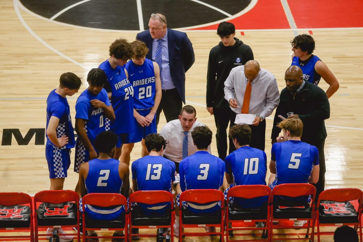 Players+huddle+around+coach+Steven+Siracusa+during+a+timeout+against+the+Elizabeth+Minutemen+on+Feb.+12.+The+SPF+Boys+Basketball+team+finished+the+22-23+season+with+a+record+of+16-10+and+made+it+to+the+sectional+quarterfinals.