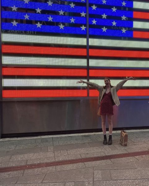 Sophomore Millie Stevens poses in front of the American flag. She is studying abroad in the U.S. for six months. 