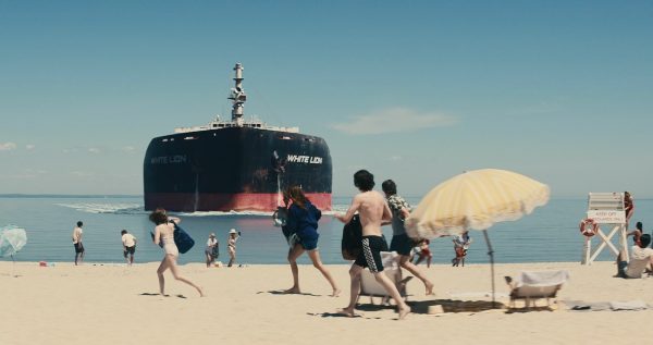 A ship is coming towards a beach with people on it. This was the first strange incident that happened in the movie. 