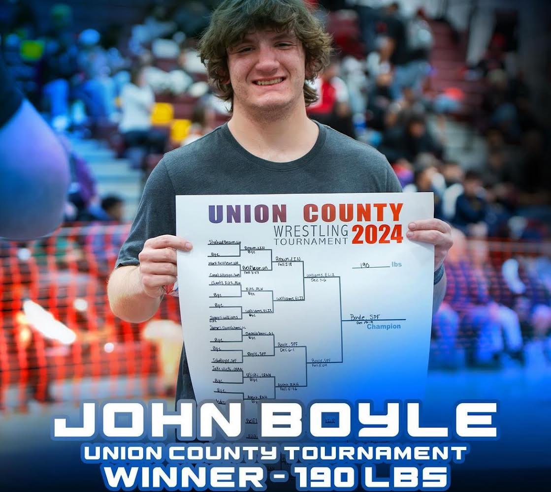 SPF wrestler John Boyle holds the bracket that he came first in. Boyle was the first individual winner since Robert Lerner in the 2021-2022 season.