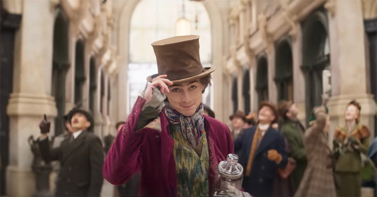 Timothée Chalamet tips his hat in a scene from “Wonka”. Chalamet starred in the film alongside other famous actors such as Hugh Grant, Olivia Colman, Rowan Atkinson, and many others. 