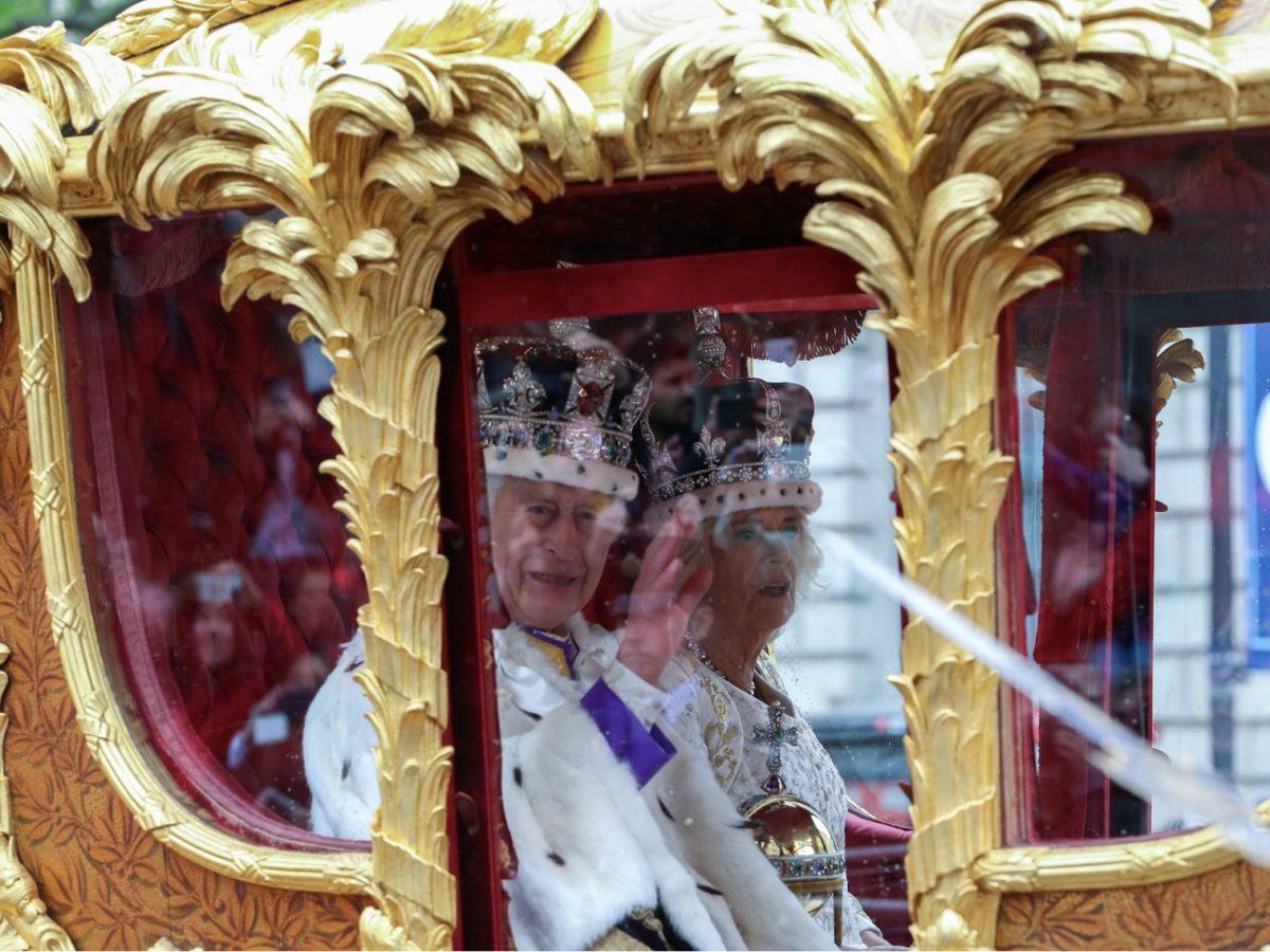 King Charles waves from a carriage on May 6, 2023, the day of his coronation. The coronation of King Charles was the first coronation since his mother, the late Queen Elizabeth II, became queen in 1952.