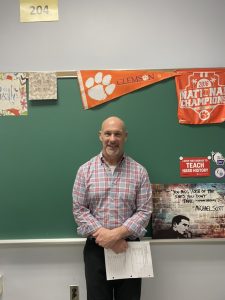 Perotti poses in front of the chalkboard in his classroom. He has been temporarily teaching at SPF for a maternity leave replacement. 