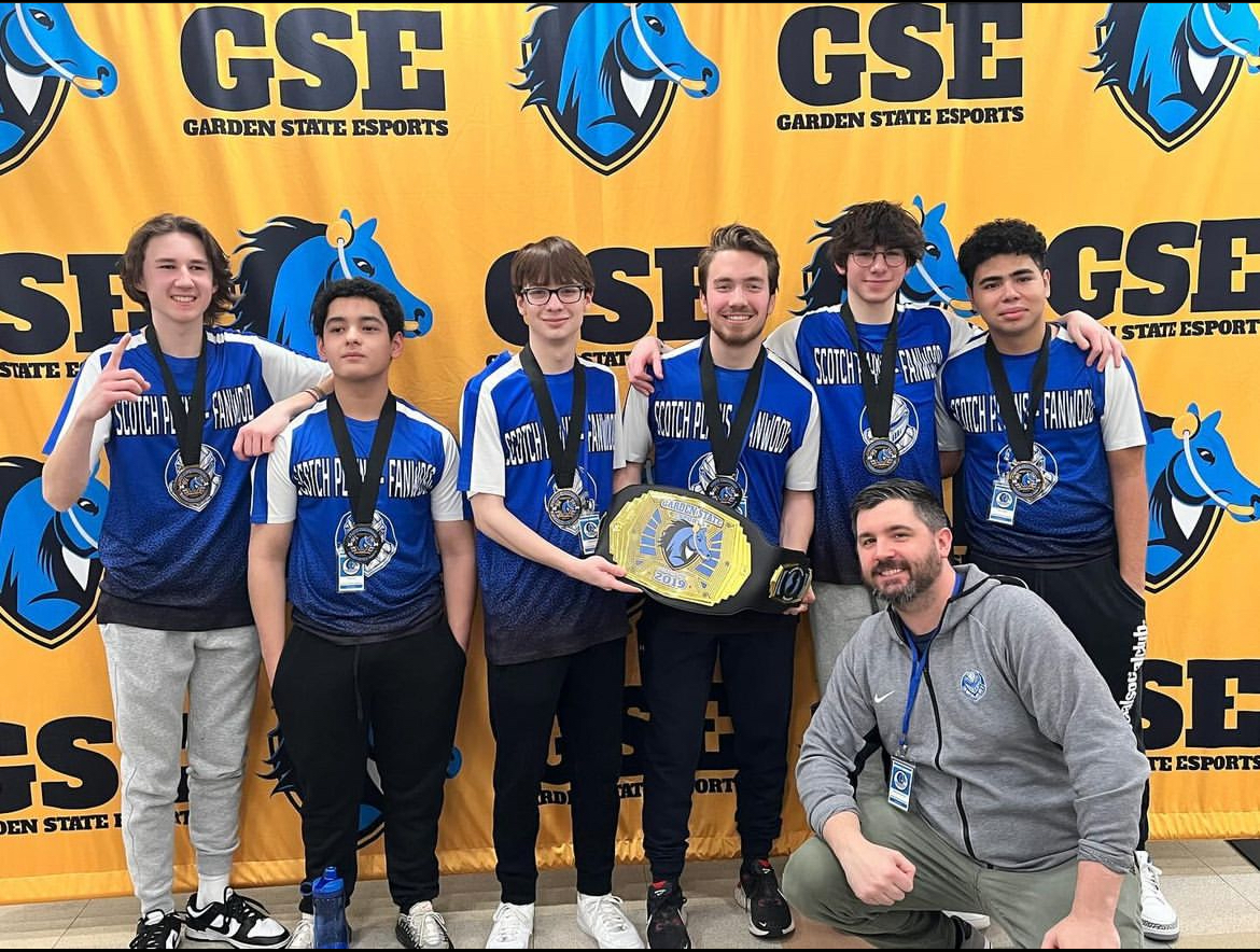 The Raider Esports Overwatch II team poses with their state championship trophy. The team repeated as state champions on Feb. 24.