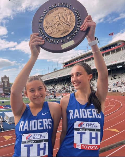 Seniors Abi Elliott and Keira Kelly pose with the “Penn Wheel” after coming in first place in their heat at Penn Relays. Elliott opened the race with a 1:03.76 400, and Kelly anchored the team with a 59.31 second 400 to conclude the race.