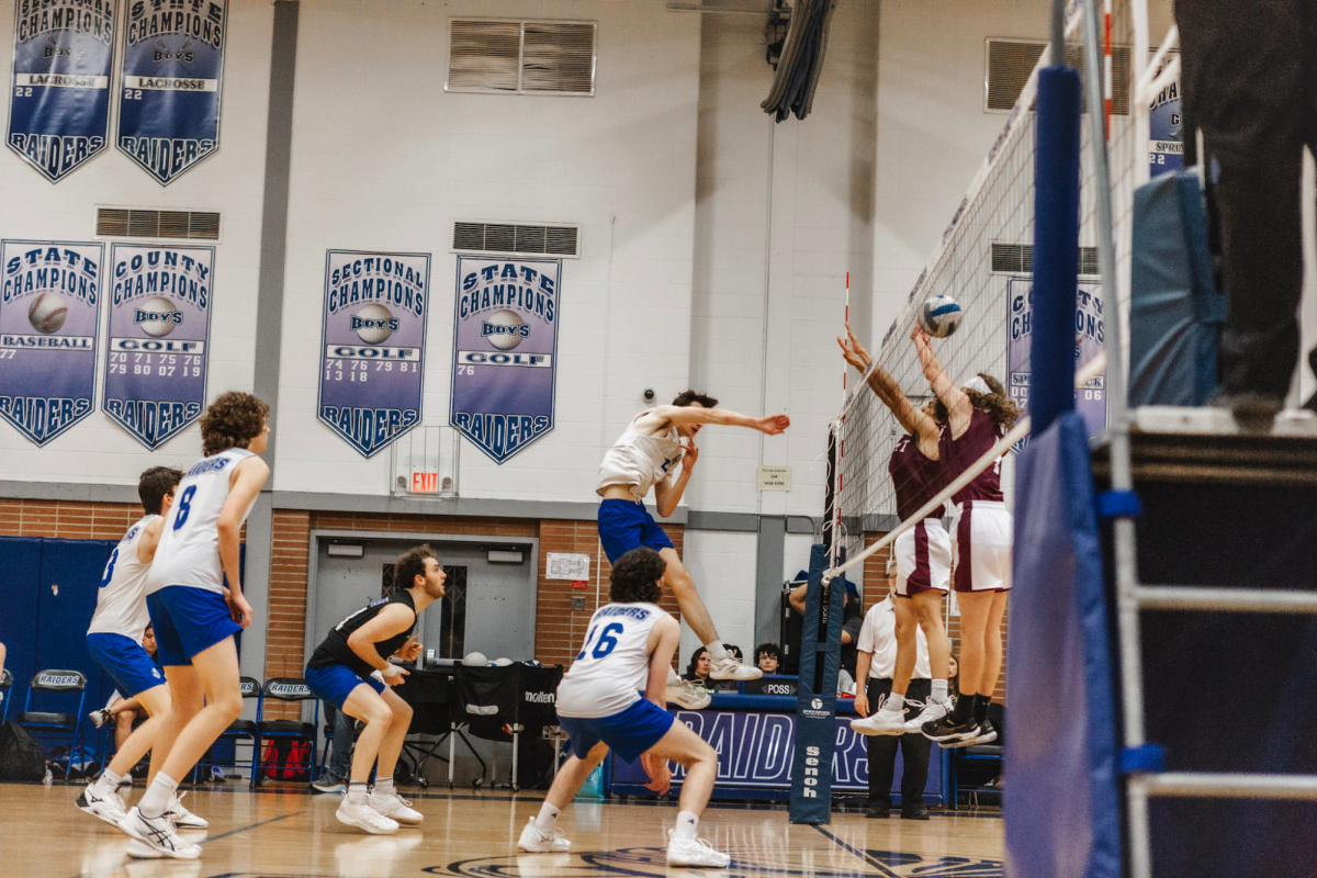 Outside+hitter+Tim+Ennis+spikes+the+ball+against+Summit+blockers.+Ennis+reached+1%2C000+career+kills+in+the+county+semifinal+game+against+the+Elizabeth+Minutemen+on+Wednesday%2C+May+15.+