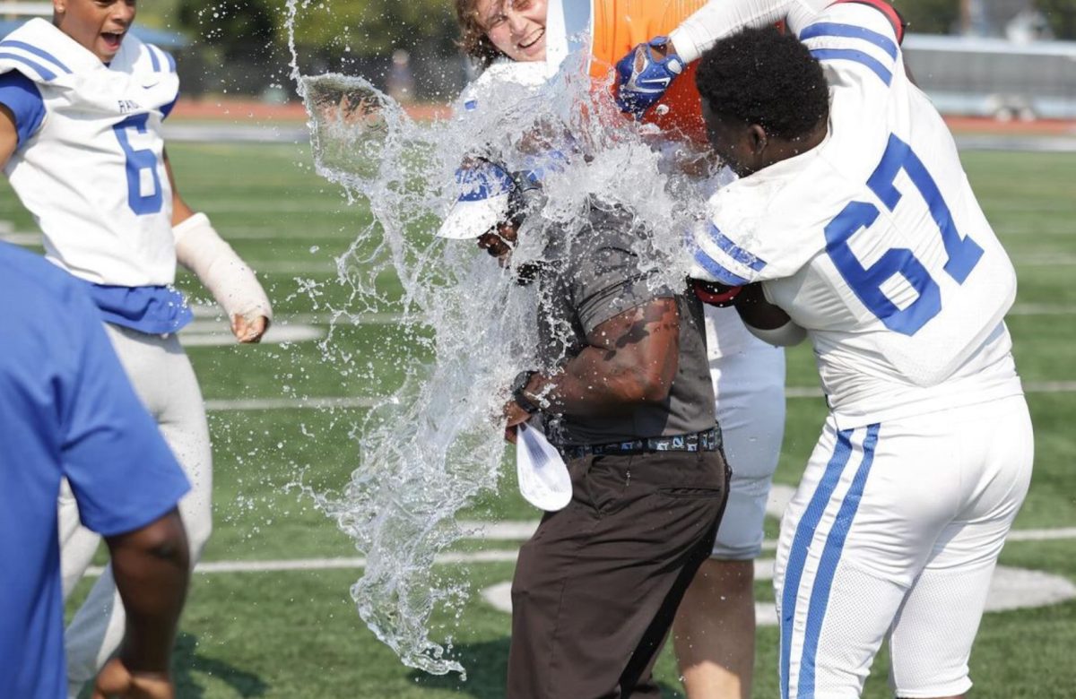 Senior offensive and defensive linemen Jerry Mundle No. 67 and Shane Hickey drop an ice bath on head coach Shawn Johnson. The Scotch Plains-Fanwood football team shut out New Brunswick 42-0 on Saturday, Sept. 14 for Johnson’s first career win. 