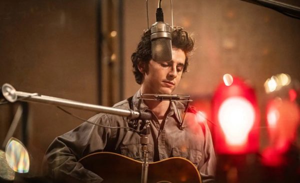 Actor Timothee Chalamet plays the guitar and sings in a scene from “A Complete Unknown.” The film, which is a Bob Dylan biopic, was released on Dec. 25, 2024.