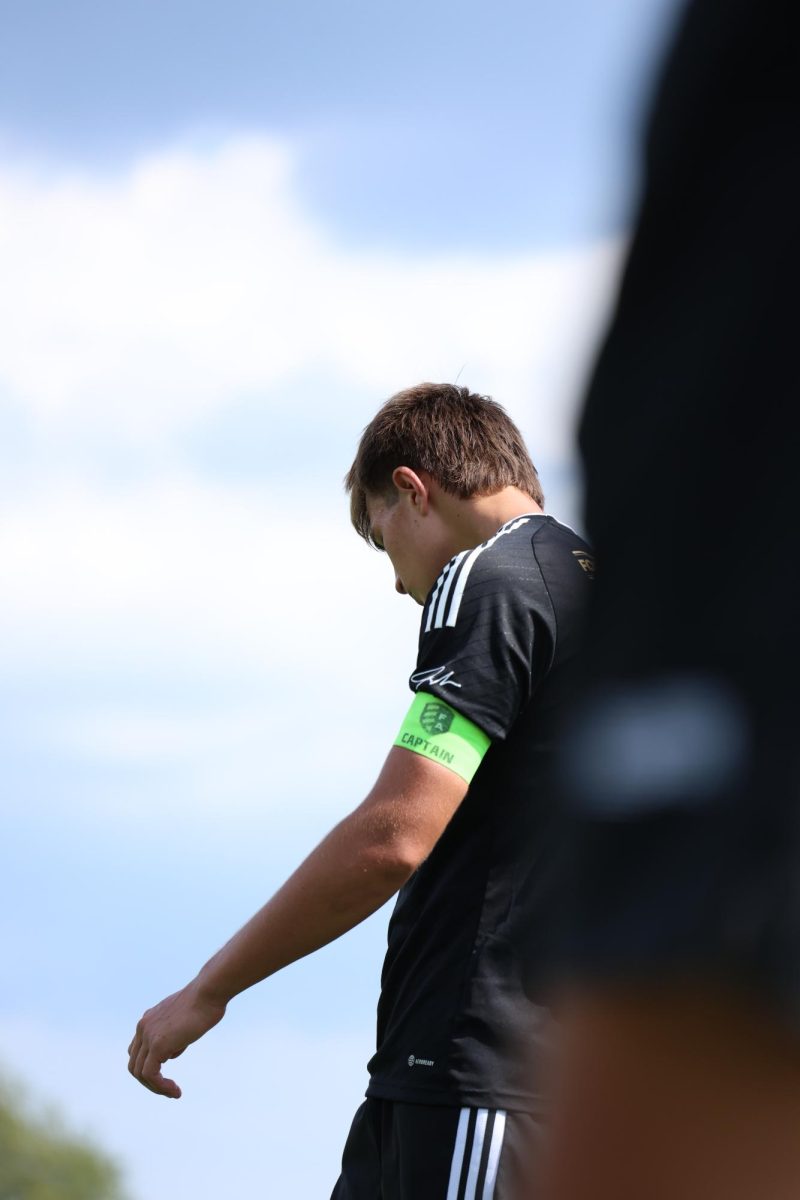 Alex Pando, defender for The Football Academy, looks down in determination as he walks up the field. This intense match resulted in a 2-1 win for the FA over PDA with three players sent off on red cards.