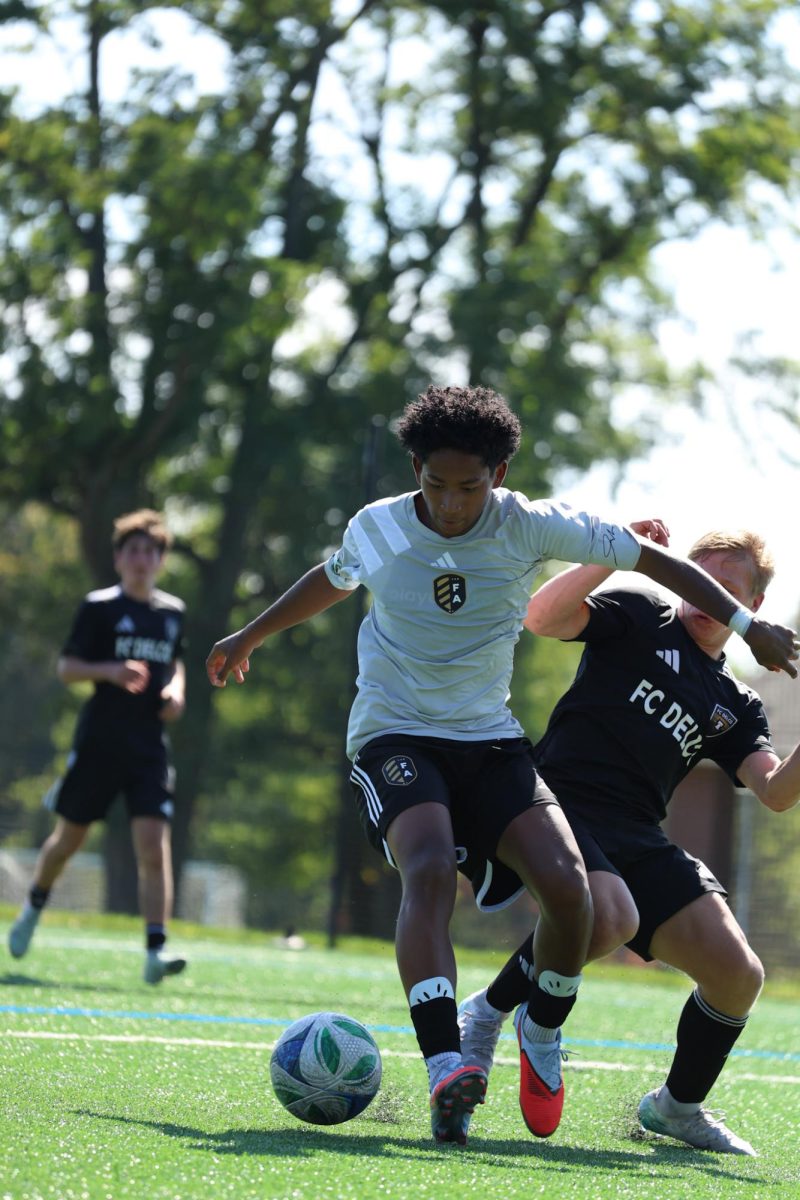 No. 15 Bellamy Macias, attacking midfielder for The Football Academy challenges Delco player for the ball spiraling away from a corner clearance. This match resulted in a casual win for FC Delco.