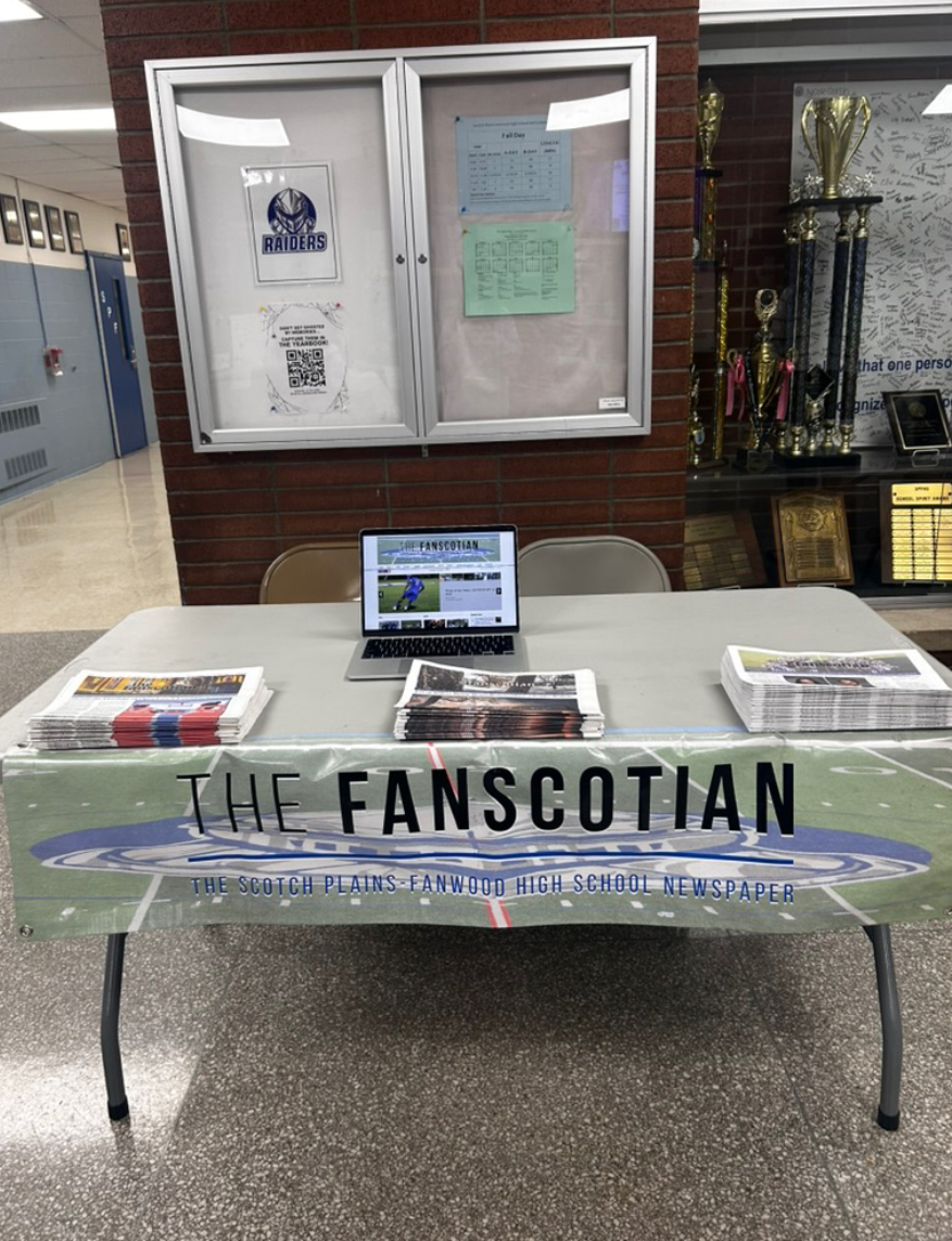 The Fanscotian table showcases previous issues at Back to School Night. Student representatives distributed issues to interested parents.