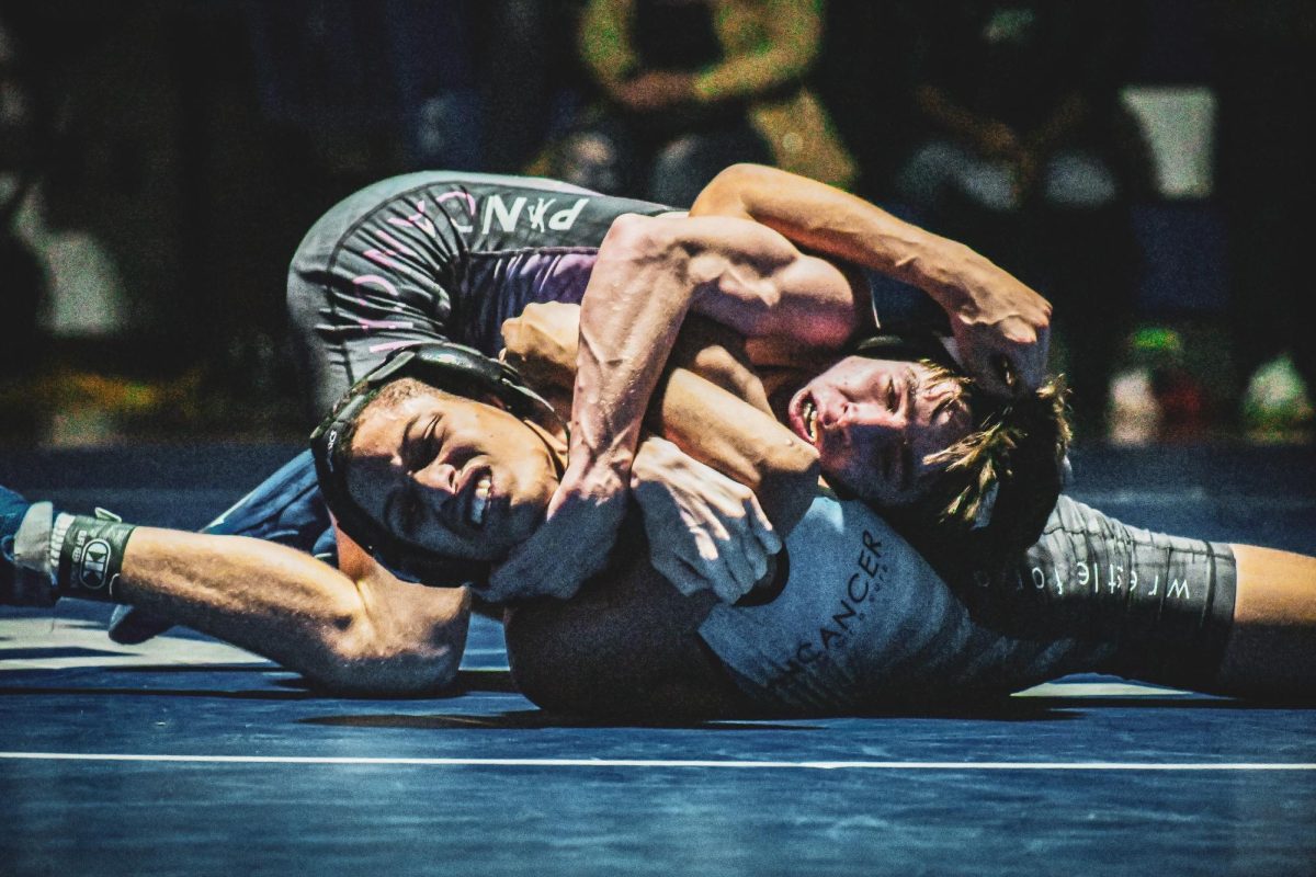 SPF wrestler Daniel McArdle pins Plainfield wrestler Miguel Lopez, earning six points for his team. The Raiders defeated the Cardinals at home on Jan. 10 for Pin Cancer Night. 