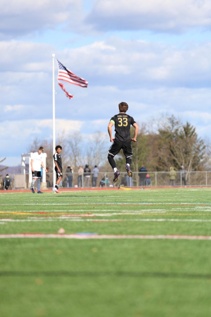 No. 33 Captain Alex Pando leaps into the air in front of the American flag as the match commences. The game resulted in a win for The Football Academy over Keystone FC in preparation for MLS NEXT FEST. 