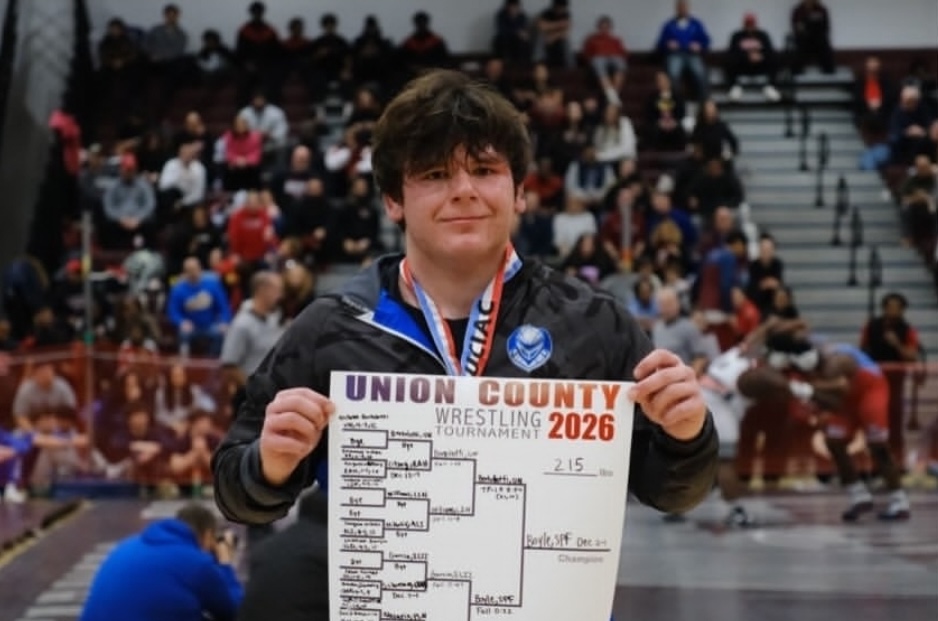 Senior Paul Boyle stands holding the bracket of the individual Union County Tournament. Boyle won the tournament and beat Union wrestler Nicholas Bertolotti in the finals.
