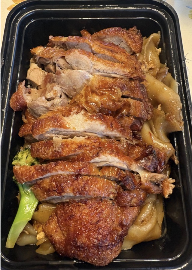 A photo of Thai Mama's Pad See Ew with Duck. Pad See Ew is typically a glass noodle dish usually served with protein and sparse greens like carrots or broccoli. 
